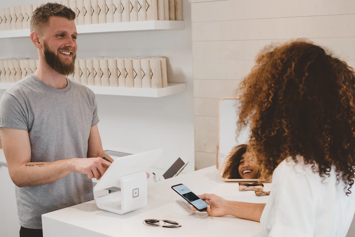 Shop owner taking a card payment from a customer